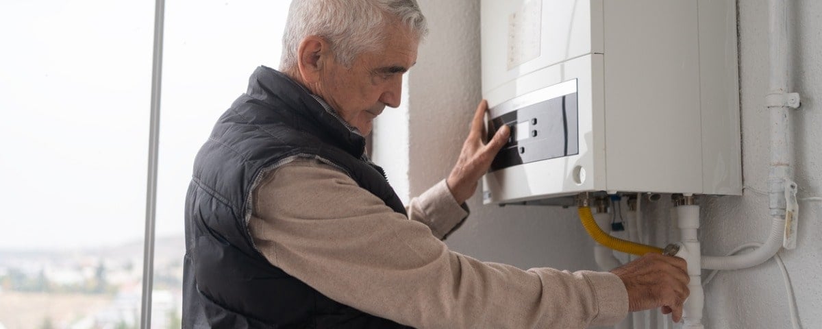 Senior Man Controlling The Boiler